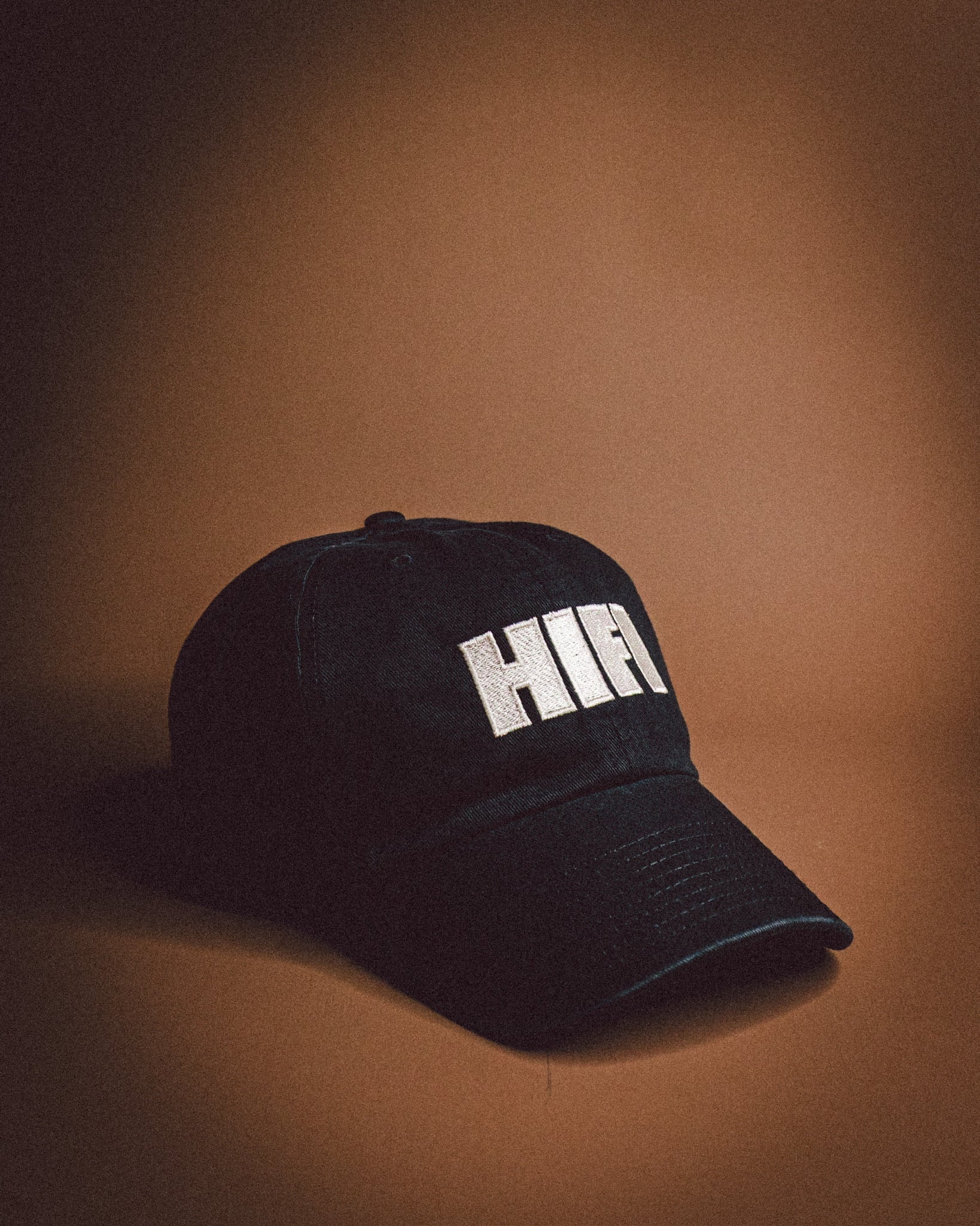 Black cap with 'HIFI' text on a brown background