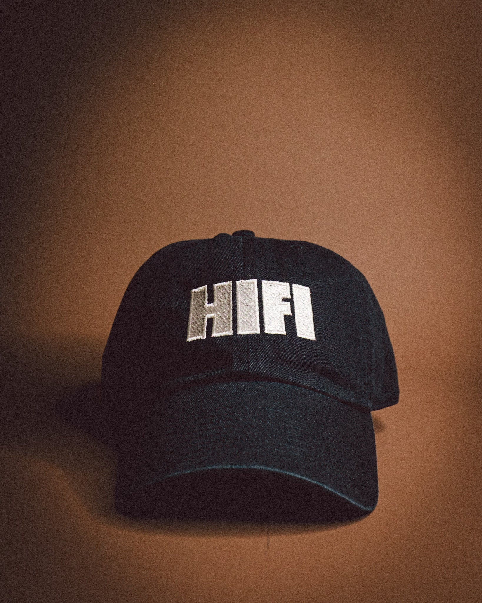 Black cap with 'HIFI' text on a brown background
