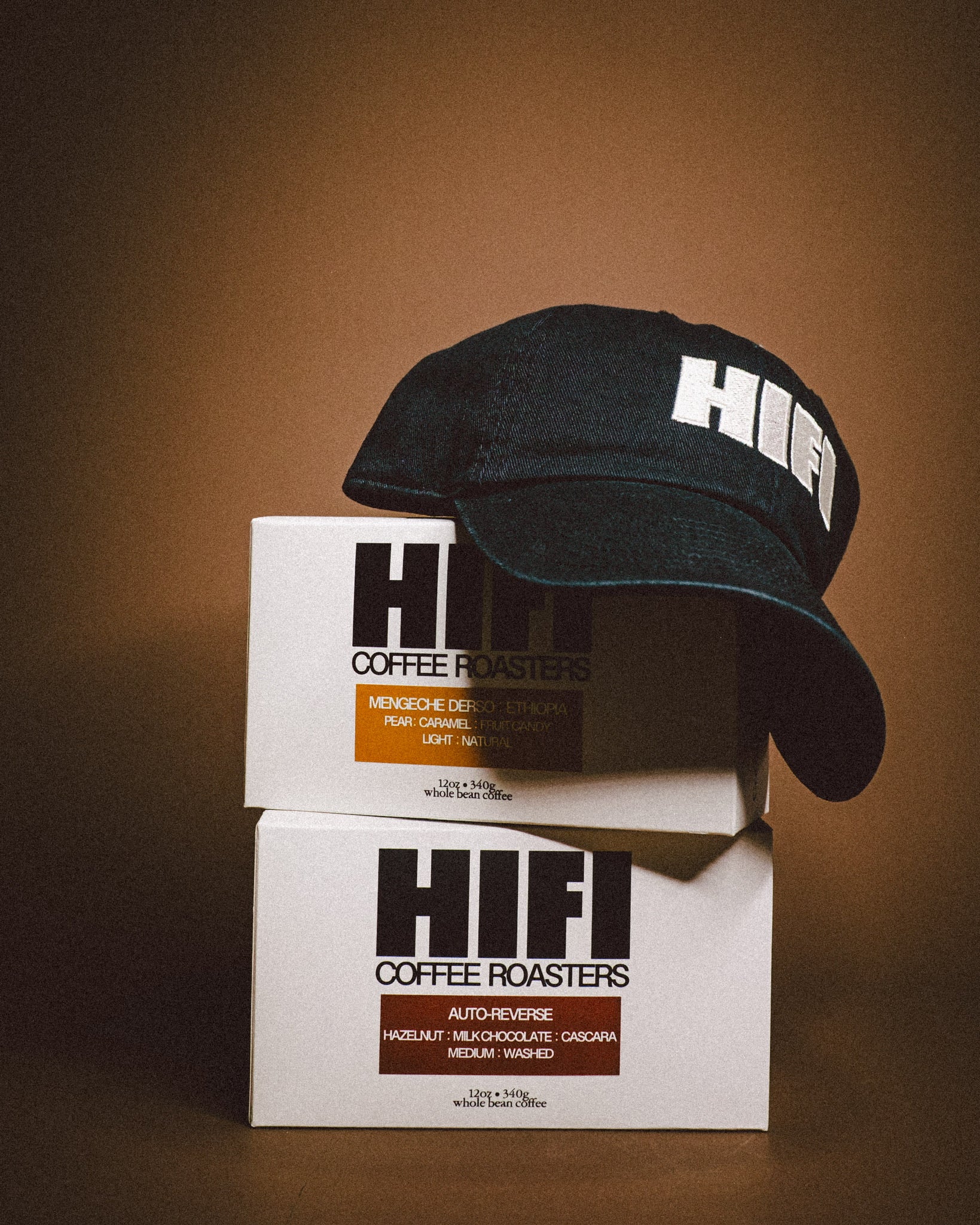 Black cap and HIFI Coffee boxes on a brown background